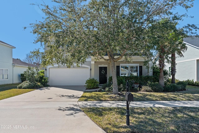 view of property hidden behind natural elements with a garage and a front yard