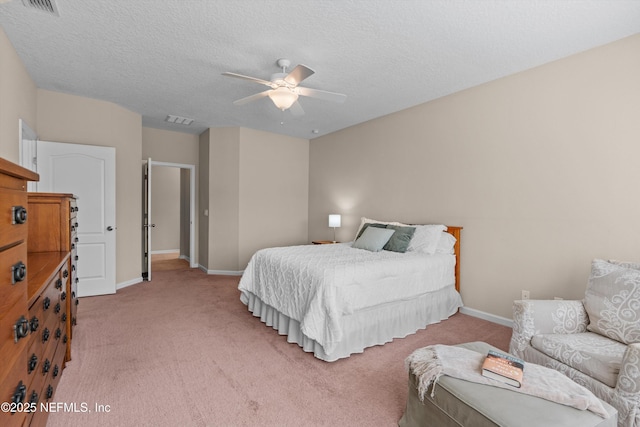 carpeted bedroom featuring a textured ceiling and ceiling fan