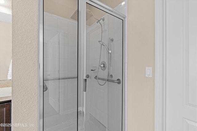 bathroom featuring walk in shower and a textured ceiling