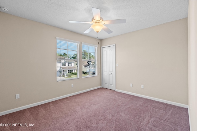 unfurnished room featuring light colored carpet, a textured ceiling, and ceiling fan