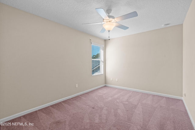 carpeted spare room with ceiling fan and a textured ceiling