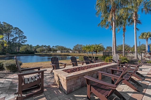 view of patio / terrace featuring a water view and an outdoor fire pit