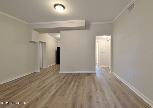 unfurnished room with crown molding and light wood-type flooring