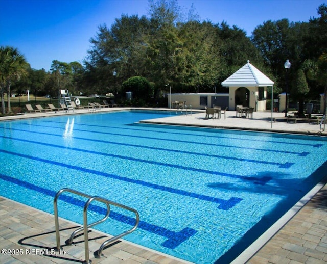 view of swimming pool featuring a patio area