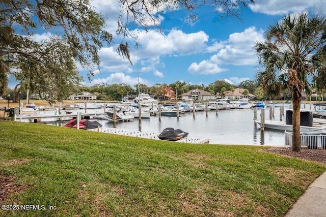 view of dock with a water view and a yard