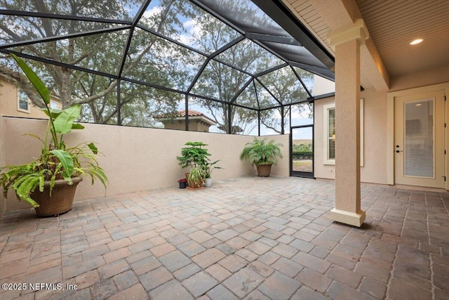 view of patio / terrace featuring glass enclosure