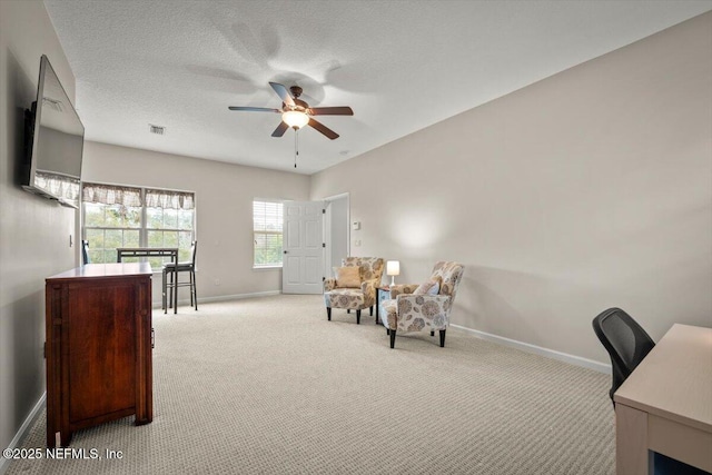 home office with ceiling fan, light carpet, and a textured ceiling