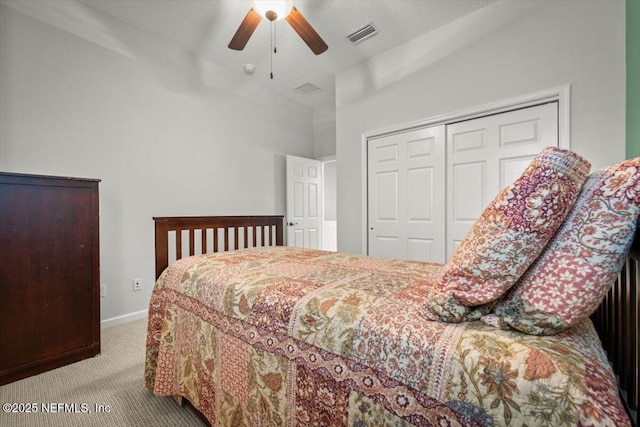 bedroom featuring lofted ceiling, light colored carpet, ceiling fan, and a closet