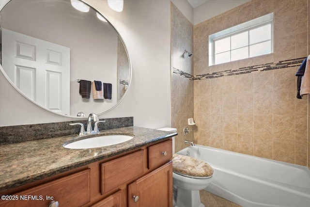 full bathroom featuring tiled shower / bath combo, vanity, and toilet