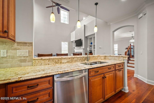 kitchen featuring dishwasher, light stone countertops, sink, and crown molding