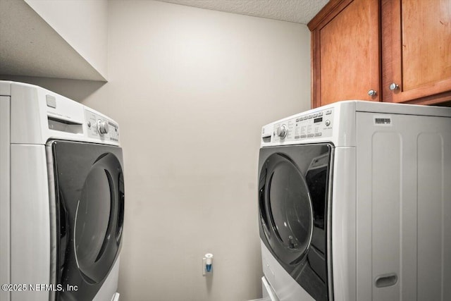 laundry room with cabinets and a textured ceiling