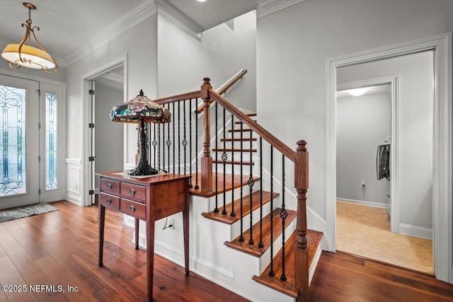 entrance foyer featuring crown molding and dark hardwood / wood-style floors