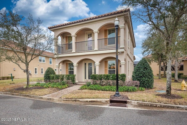 mediterranean / spanish-style home featuring a balcony