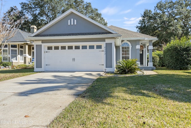 view of front of house with a garage and a front lawn