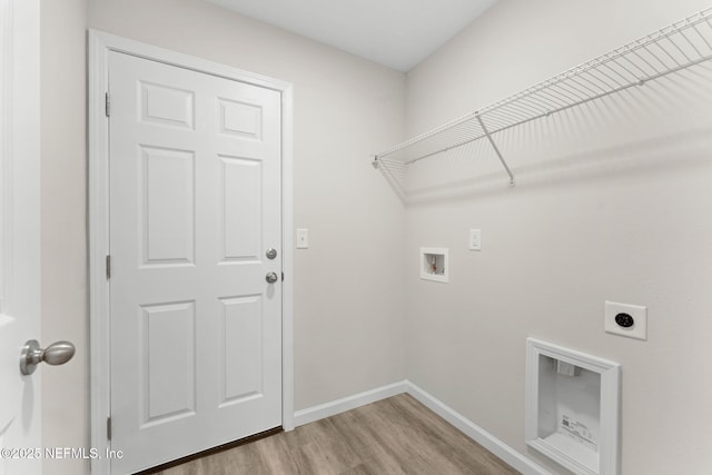 washroom with washer hookup, light hardwood / wood-style floors, and electric dryer hookup