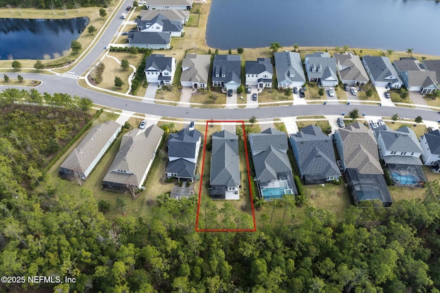 birds eye view of property featuring a water view