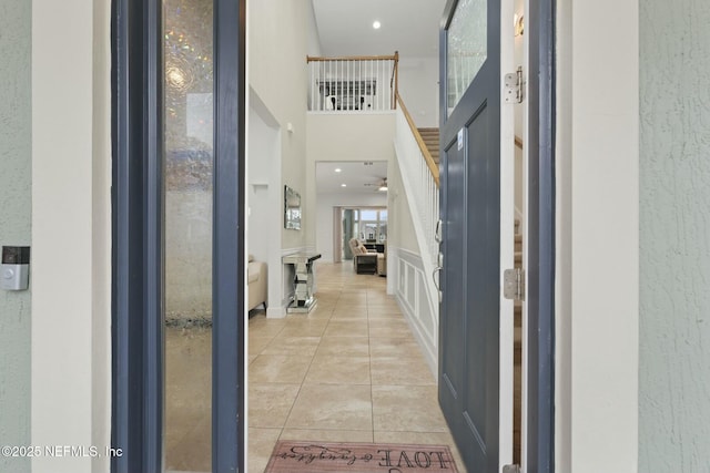 tiled entryway with a high ceiling