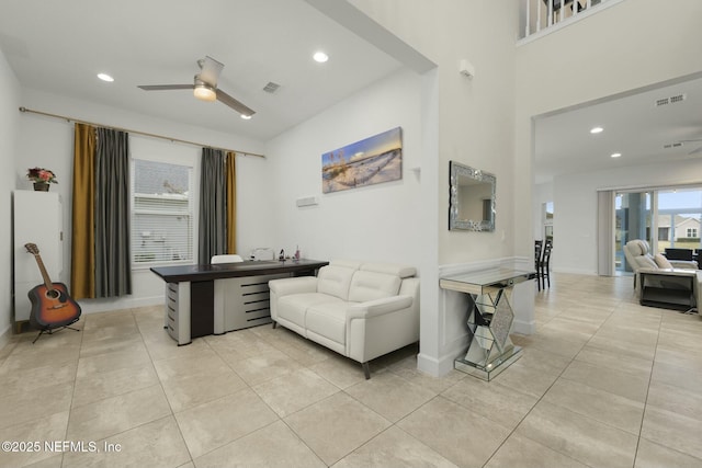 tiled living room featuring ceiling fan