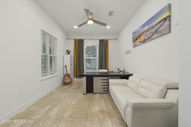 living area with ceiling fan and light tile patterned floors