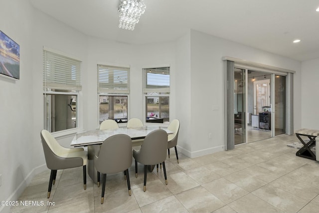 dining room with an inviting chandelier and light tile patterned floors