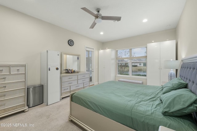 bedroom with light carpet and ceiling fan