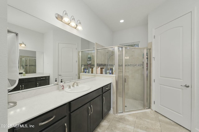 bathroom featuring tile patterned flooring, vanity, and walk in shower