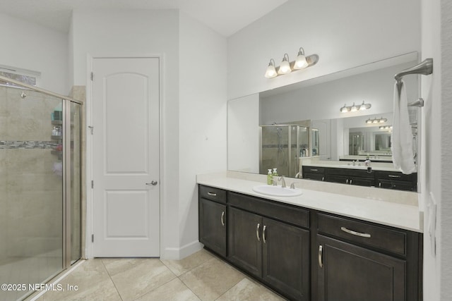 bathroom with tile patterned floors, a shower with door, and vanity