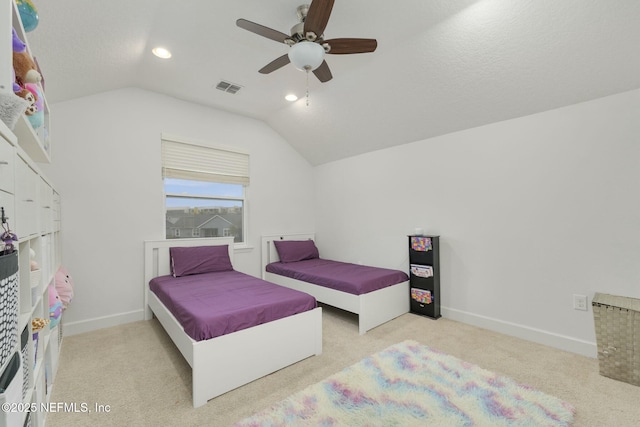 carpeted bedroom featuring lofted ceiling, a textured ceiling, and ceiling fan