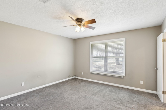 carpeted empty room with ceiling fan and a textured ceiling