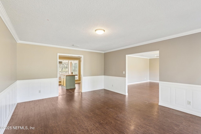 unfurnished room with ornamental molding, dark hardwood / wood-style flooring, and a textured ceiling