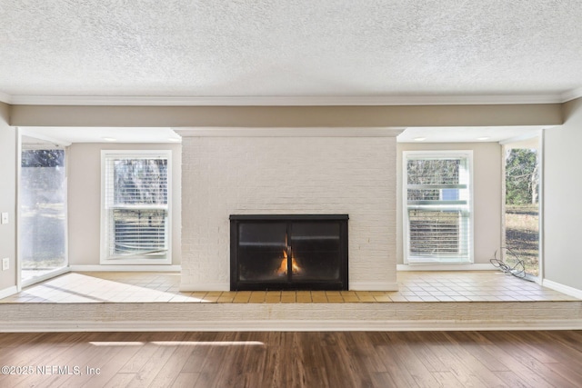 room details featuring crown molding, wood-type flooring, and a textured ceiling