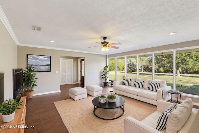 living room with crown molding, ceiling fan, plenty of natural light, and dark hardwood / wood-style flooring