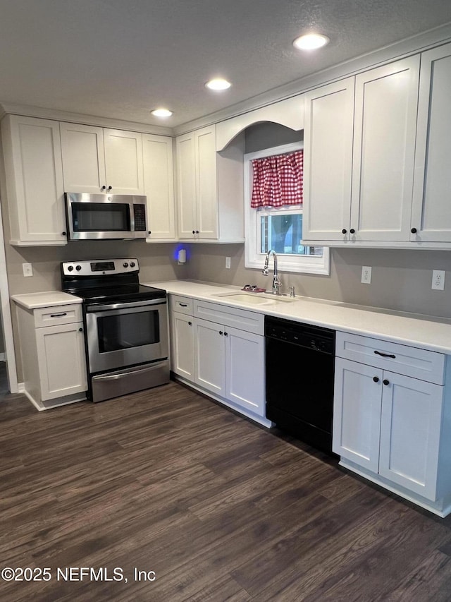 7406 SW County Road 225, Starke, FL 32091 - kitchen with stainless steel appliances, white cabinetry, and a sink