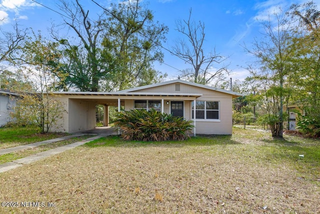 view of front facade with a carport and a front yard