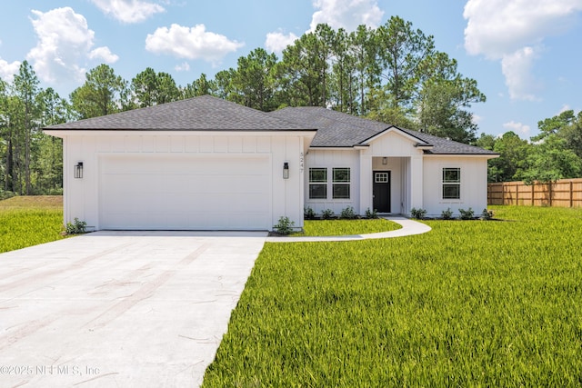 view of front facade with a garage and a front lawn