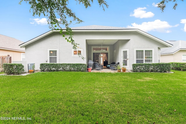 back of house featuring a patio area, ceiling fan, and a lawn