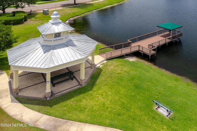 dock area with a water view and a yard