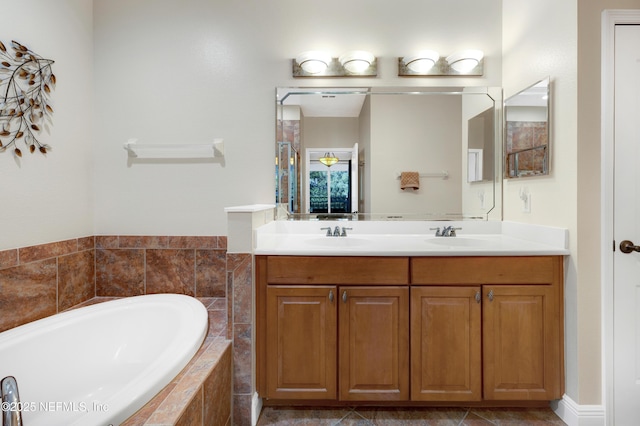 bathroom with vanity and tiled bath