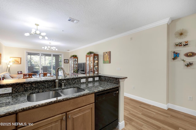 kitchen with sink, an inviting chandelier, ornamental molding, black dishwasher, and dark stone counters