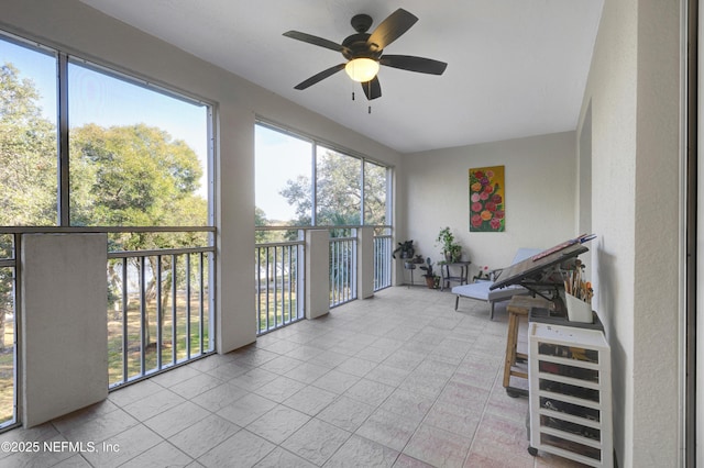 unfurnished sunroom featuring ceiling fan