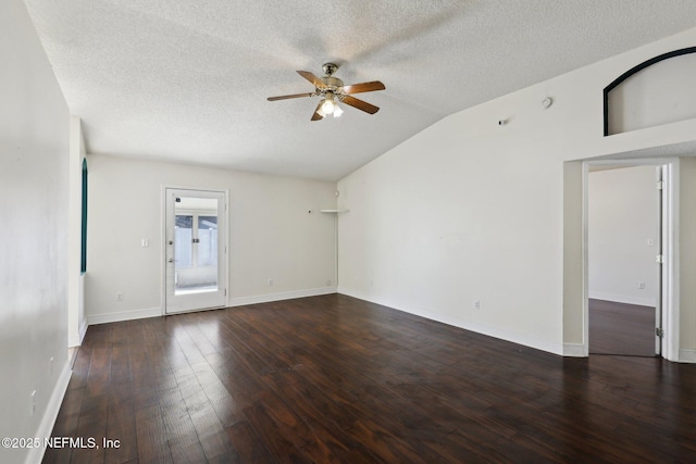 empty room with vaulted ceiling, dark hardwood / wood-style floors, a textured ceiling, and ceiling fan