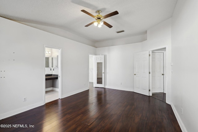 spare room featuring vaulted ceiling, a textured ceiling, ceiling fan, and dark hardwood / wood-style flooring