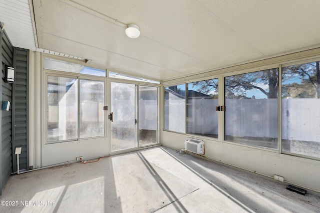 unfurnished sunroom featuring an AC wall unit