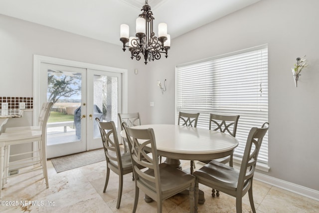 dining area featuring french doors, a notable chandelier, a healthy amount of sunlight, and light tile patterned floors