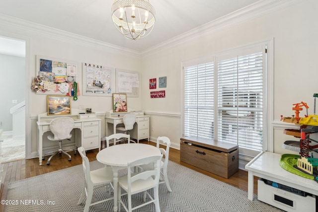 dining room with ornamental molding, a chandelier, and light hardwood / wood-style floors