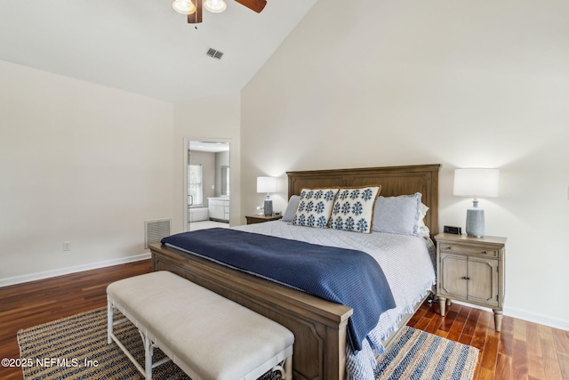 bedroom featuring dark hardwood / wood-style flooring, connected bathroom, lofted ceiling, and ceiling fan