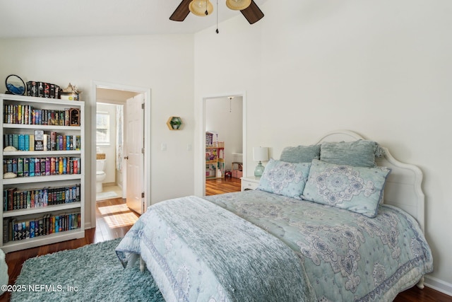 bedroom with lofted ceiling, ensuite bath, dark hardwood / wood-style floors, and ceiling fan