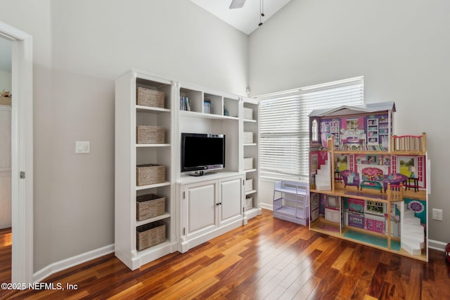 game room featuring hardwood / wood-style flooring, vaulted ceiling, and ceiling fan