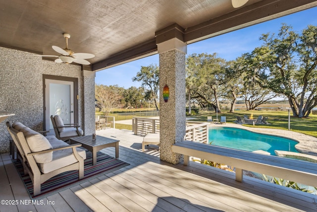 wooden deck with a yard, an outdoor hangout area, and ceiling fan