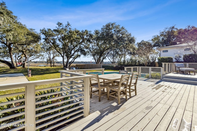 wooden terrace featuring a yard